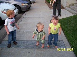 Jumping on a drain cover with my cousins.