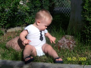 Playing with the rocks in great grandma's planter box.