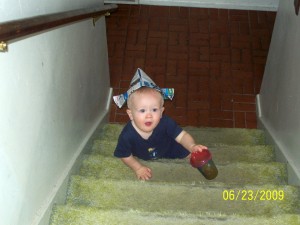 Climbing up the stairs in my newspaper hat, sippy in hand.