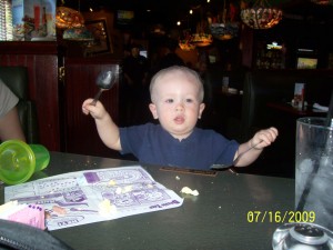 Aiden drumming with spoons.