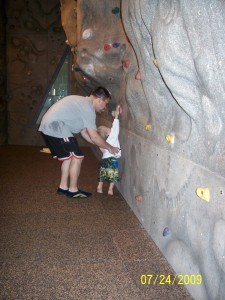 Helping Aiden rock climb.