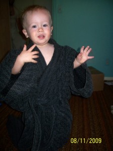 Wearing daddy's robe.