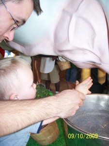 Aiden learns to milk a cow.