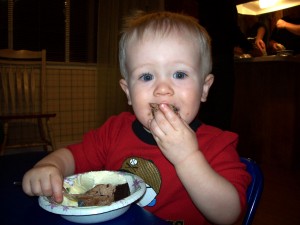 Shoving cake in my face.  Yum!