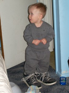 Wearing daddy's shoes.