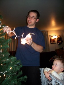 Aiden watching daddy string up the lights.