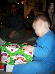 Aiden opening one of his gifts.