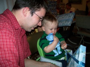 Aiden opening his gift from great grandma.