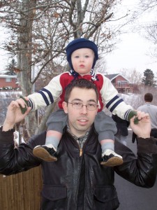 Riding on daddy at the zoo.