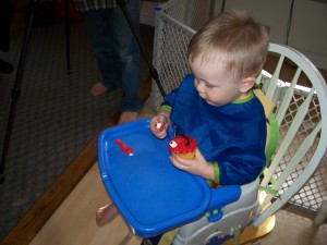 Eating his Elmo cupcake.