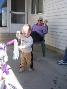 Playing outside with great grandma and grandpa Brian.