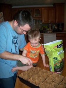 Aiden and daddy prepping our seed planter.