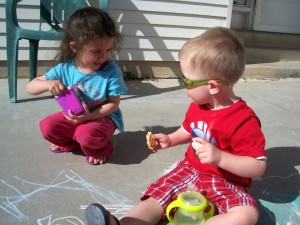 Playing with chalk outside.