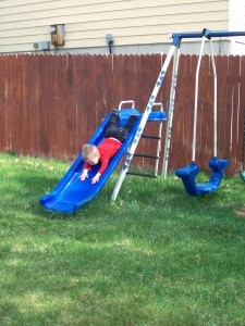 Newest feat, sliding down the slide on his belly head first.